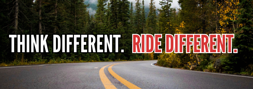 Background image of an open road winding through a forest with text: Think Different. Ride Different.
